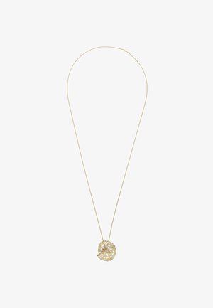 Zarte Goldkette mit dünner Kette und einem abstrakten, unregelmäßig geformten Anhänger in Durchbruchtechnik.