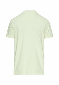 Polo à manches courtes de couleur vert clair uni, présenté de dos avec un col classique et sans logos ni motifs visibles.