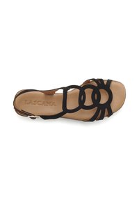 Black suede sandal with circular cutout design, open toe, and a flat beige sole. The insole features embossed "LASCANA" branding.