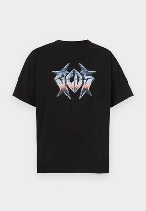 Black short-sleeve T-shirt with metallic silver and orange spiked design spelling "GCDS" across the chest.