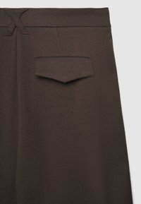 Braune, maßgeschneiderte Hose mit glatter Textur, flachem Bund, einer einzigen Gesäßtasche und einem dezenten Webmuster.