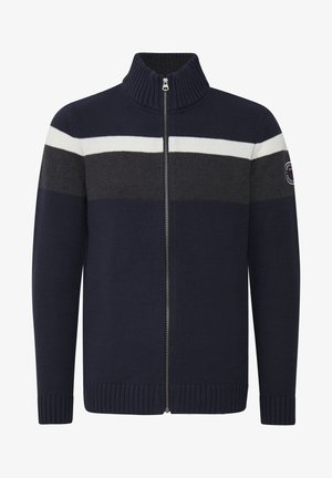 Tamsiai mėlynas zip-up megztinis su tekstūruotu audiniu, turintis horizontalius juodus ir baltus dryžius. Aukštas apykaklė ir sutraukti rankogaliai bei apačia.