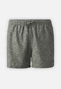 Pantalones de baño verdes hechos de tela ligera, con un sutil patrón de flores y piñas, cintura elástica y cordón ajustable.
