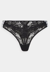 Black lace thong featuring floral patterns, sheer texture, and a contrasting waistband with logo detail. Cut low for minimal coverage.
