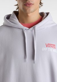 Light gray hoodie with a drawstring, featuring a red "VANS" logo and "OFF THE WALL" text in white, made from soft fabric.
