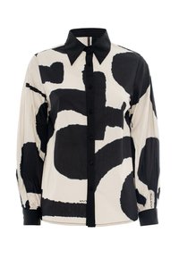 Long-sleeve shirt in beige with large black abstract patterns. Features a pointed collar and button-down front with black buttons.
