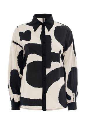 Long-sleeve shirt in beige with large black abstract patterns. Features a pointed collar and button-down front with black buttons.