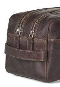 Neceser de piel marrón con forma rectangular, doble cremallera y detalles de costura. Cuenta con una correa lateral para facilitar su manejo.