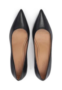 Black leather pumps with a pointed toe and cutout sides. Interior features a tan lining with visible stitching details.