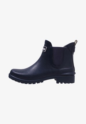 Navy blue waterproof ankle boot with elastic side panels, textured rubber sole, and a pull tab at the back for easy wear.