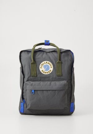 Gray nylon backpack with green handles, blue accents, front pocket, and circular logo. Rectangular shape with a zip closure. Textured surface.