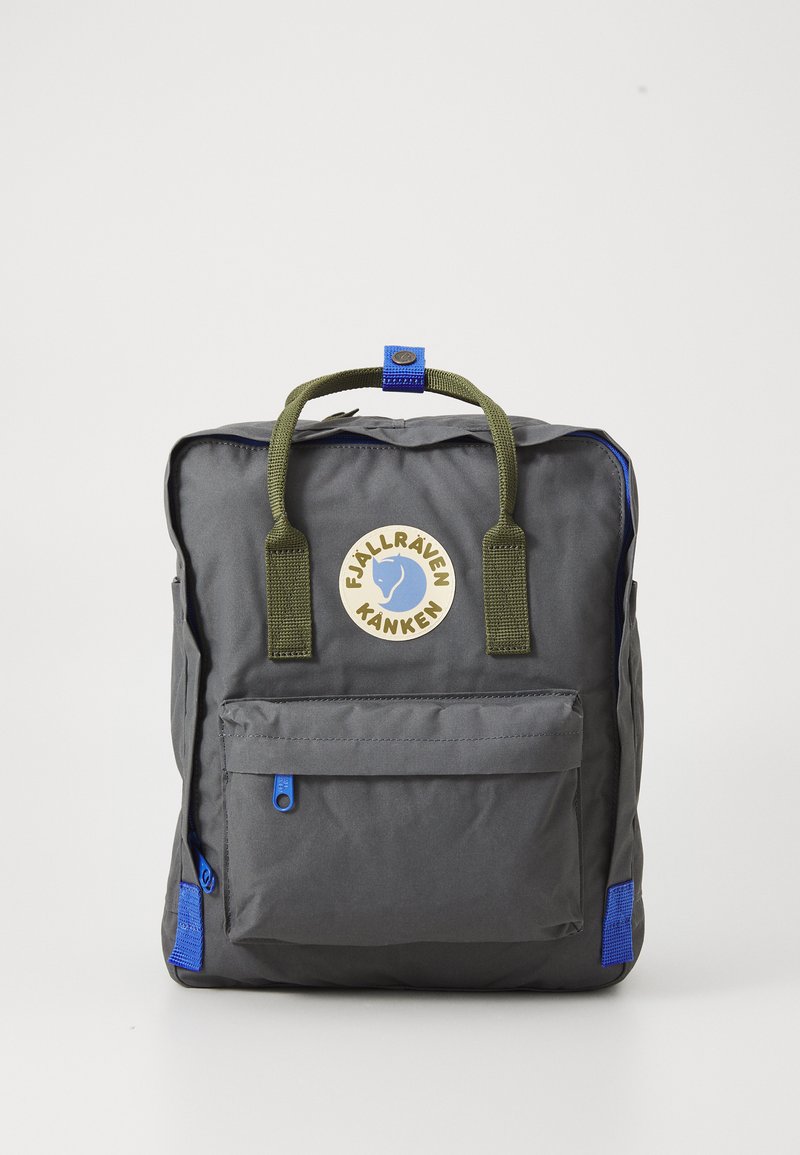 Gray nylon backpack with green handles, blue accents, front pocket, and circular logo. Rectangular shape with a zip closure. Textured surface.