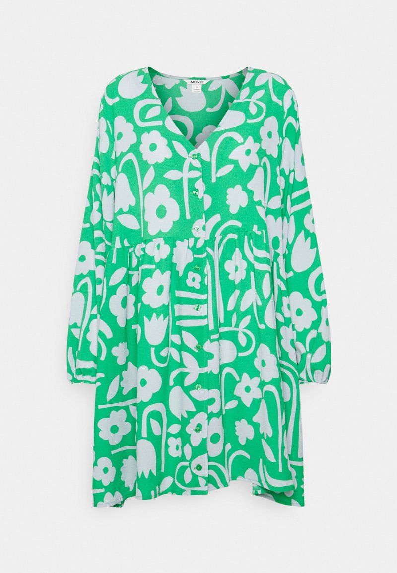 Abito verde con un motivo floreale bianco, presenta una scollatura a V, maniche lunghe e chiusura a bottoni sul davanti. Tessuto morbido con una silhouette fluida.