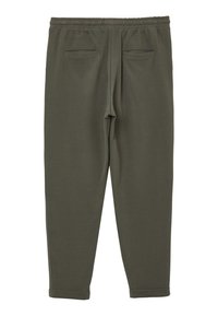 Olivgrüne, zulaufende Sweatpants mit elastischem Bund, ausgestattet mit zwei Gesäßtaschen und einem weichen, strukturierten Stoff. Bündchen an den Knöcheln.