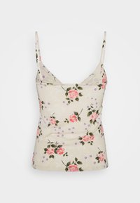 Haut bustier floral en coton beige clair avec des roses roses et des accents violets. Caractérisé par des bretelles fines et un décolleté en forme de U. Coupe ajustée.