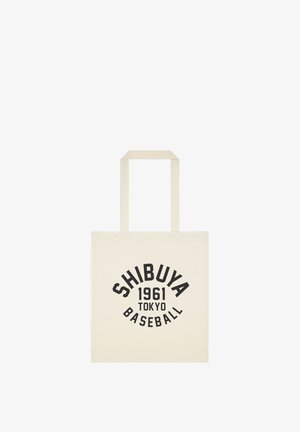 Płócienna torba z czarnym napisem Shibuya 1961 Tokyo Baseball na kremowym tle.