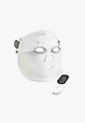 White LED facial mask with eye, nose, mouth openings and attached digital remote control for skin treatment.