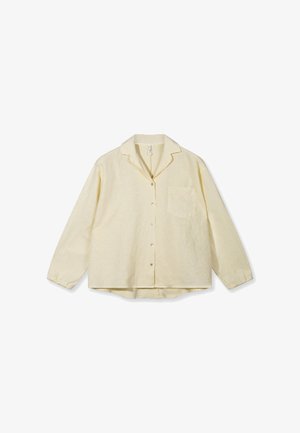Cream-colored long-sleeve button-up shirt with collar and chest pocket, laid flat on a white background.