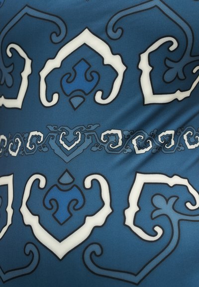 Blue fabric with symmetrical white and black geometric and scroll-like patterns forming horizontal rows.