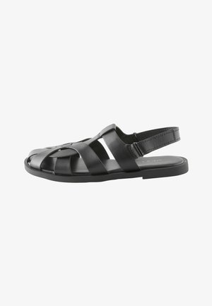 Meeste mustast nahast sandaal kootud rihmadega, reguleeritava tagumise rihmaga, tasapinna ja avatud varbaga disainiga.