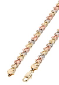 Kolmivärviline metalline käevõru, millel on omavahel ühendatud kolmnurkse kujuga lingid kullast, roosast kullast ja hõbedast, ning kindel lukustus.