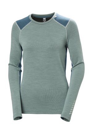 Long-sleeve shirt in light green with textured fabric, contrasting blue panels on shoulders, and reflective accents on sleeve.