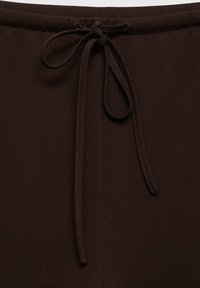 Brown fabric waistband with a tie detail, featuring a smooth texture and a subtle sheen, designed for adjustable fit.