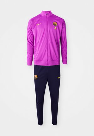 Barça tracksuit with a zip-up purple jacket and navy pants, featuring the logo and yellow accents; made of smooth, lightweight material.