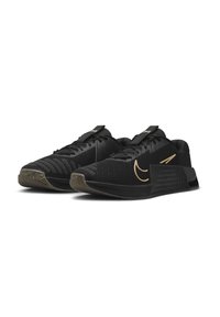 Scarpe sportive nere con una tomaia in mesh testurizzato, dettagli dorati e una suola in gomma stampata per una migliore aderenza. Include lacci piatti e tallone rinforzato.