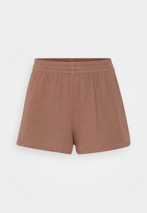 Cotton shorts in a dusty rose color, featuring an elastic waistband, loose fit, and subtle textured pattern throughout the fabric.