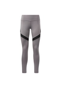 Leggings atletici grigi con un design aderente. Presentano accenti neri e pannelli laterali, una texture liscia e una vita alta per un supporto migliore.