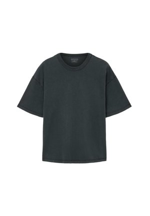 Sort bomulds t-shirt med korte ærmer, rund halsudskæring og synlige syninger. Løs pasform og glat tekstur.