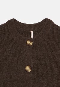 Brown knitted cardigan featuring a textured fabric, crew neckline, and two round buttons in a marbled design. Label reads "ONLY."