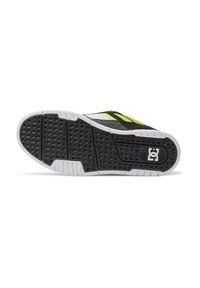 Black and neon green sneaker sole with a textured rubber grip, featuring white accents and a prominent logo on the side.