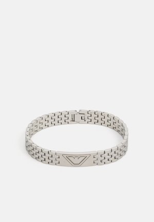 Silver metal bracelet with a woven design, featuring a rectangular clasp and an accent plate with a triangular logo.