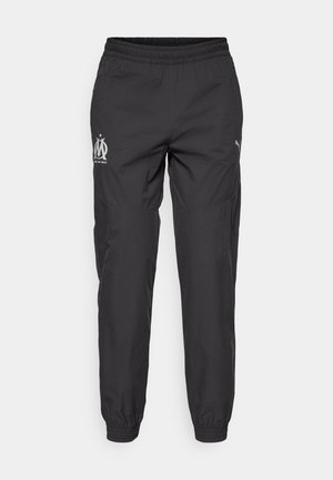 Schwarze Sporthose aus leichtem Stoff. Sie verfügt über einen elastischen Bund, Seitentaschen und graue Logos auf beiden Seiten.