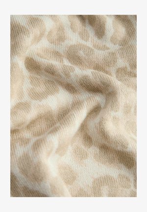 Beige en witte gebreide stof met een zacht, golvend patroon en zichtbare textuure vouwen.