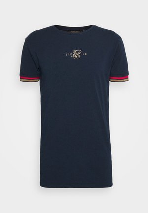 Navy blue t-shirt made of cotton, featuring short sleeves with red, beige, and black stripes and gold logo detail on the chest.