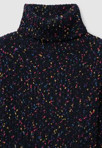 Black turtleneck sweater with a textured pattern featuring colorful specks of pink, yellow, and blue throughout the fabric.