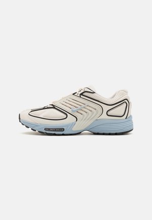 Athletic sneaker featuring a light beige upper with black and blue accents, breathable mesh, textured overlays, and a black rubber sole.