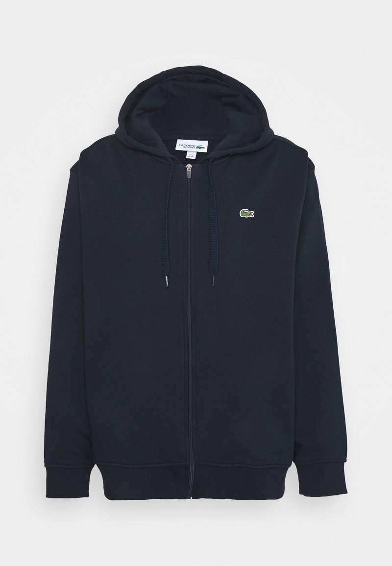 Felpa con zip di colore blu navy realizzata in tessuto misto cotone, dotata di tasca a marsupio, cappuccio con cordino e un piccolo logo verde sul petto.