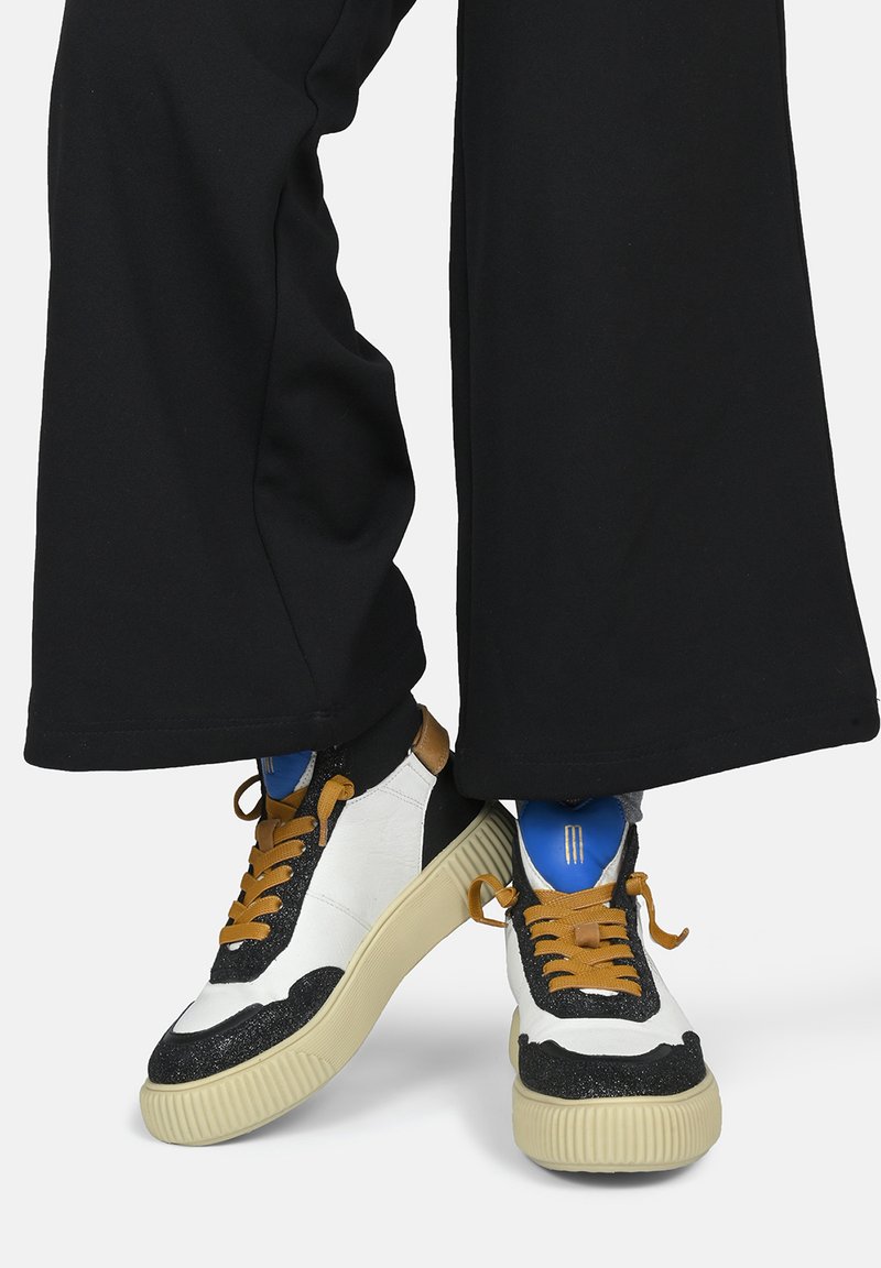 High-top sneakers with white leather and black glitter accents, beige rubber sole, brown laces, and a blue interior.