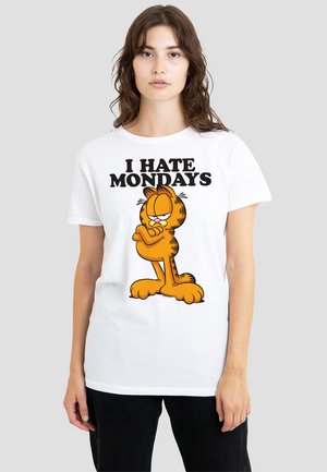 White t-shirt featuring an orange cartoon cat with a serious expression and the text "I HATE MONDAYS" in bold black letters.