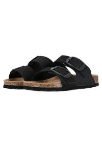 Svarta sandaler med två justerbara remmar, korkfotbädd och strukturerad gummisula. Har en minimalistisk design och slät matt yta.