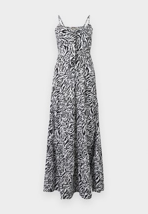 Maxikjole med zebra-print i sort og hvit. Har tynne stropper, en tettsittende midje og en flytende skjørt med lagdelt kant. Lett stoff.