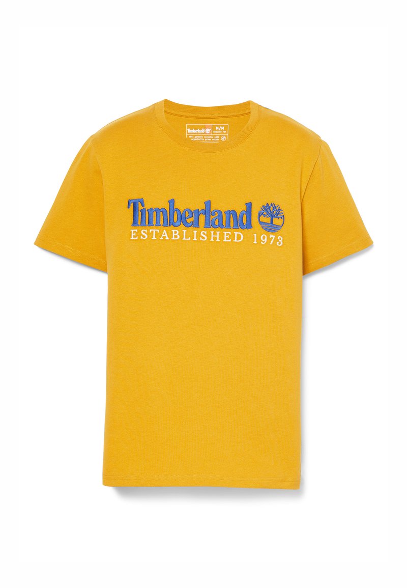 Żółta bawełniana koszulka z krótkim rękawem z niebieskim haftowanym logo "Timberland", napisem "ZAŁOŻONA W 1973" oraz grafiką drzewa poniżej tekstu.