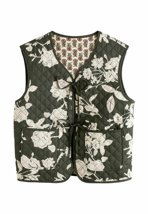 Veste sans manches matelassée avec fond vert foncé et grand imprimé floral blanc, deux poches avant et fermetures à nouer, doublure fleurie à l'intérieur.