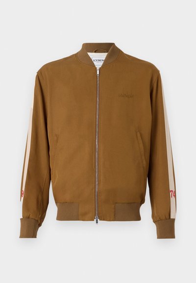 Brown bomber jacket with ribbed hem and cuffs, zip closure, side pockets, and beige accent stripes featuring red number detail.