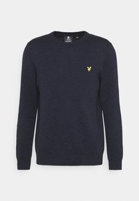 Mörk marinblå långärmad tröja med rundad halsringning, ribbad mudd och nederkant, med en liten gul fågel-logotyp på vänster bröst.