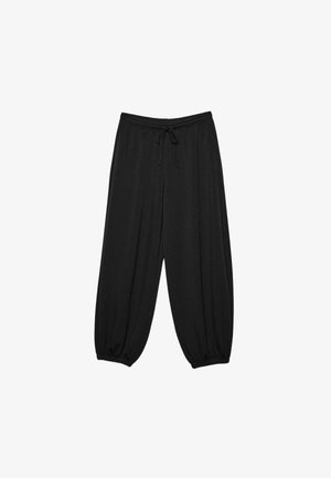Schwarze Sweatpants mit lockerem Sitz, elastischem Bund und Kordelzug, zulaufende Beine mit elastischen Bündchen.